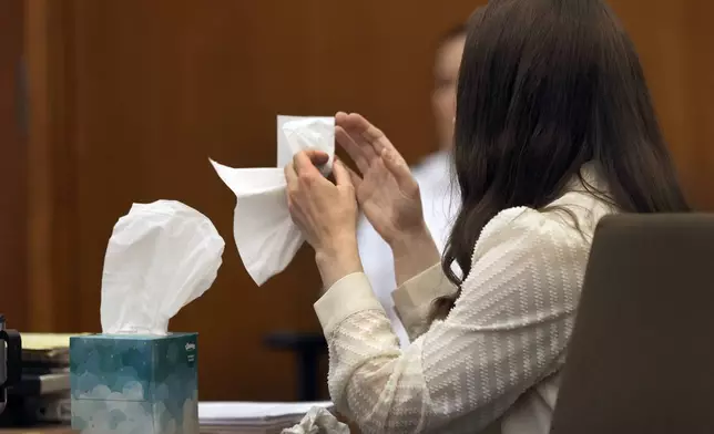 Lindsay Clancy grabs a tissue after witness Elaine Rossi, the nanny to the Clancy children, testified during her murder trial at Plymouth Superior Court in Plymouth, Mass., Wednesday, Aug. 5, 2026. (David L Ryan/The Boston Globe via AP, Pool) CORRECTION: Source is The Boston Globe, not The Boston Herald.