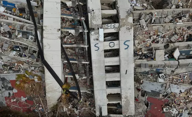 FILE - A building damaged during the earthquakes is marked with "S.O.S." painted stands in La Guaira, Venezuela, July 2, 2026. (AP Photo/Matias Delacroix, File)