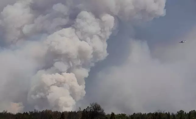 A Russian Il-76 firefighting plane battles a forest fire in Deliblatska Pescara (Deliblato Sands), near the village of Sumarak, 70 kilometers north-west of Belgrade, Serbia, Thursday, Aug. 20, 2026. (AP Photo/Darko Vojinovic)