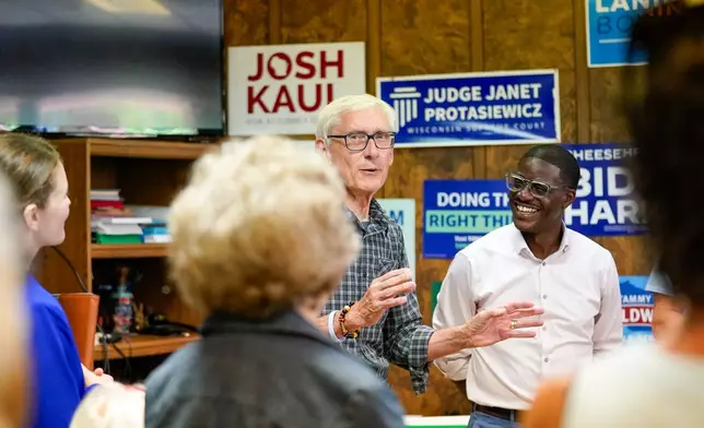 Wisconsin Gov. Tony Evers, center left, speaks in support of David Crowley, right, Democratic candidate for Wisconsin governor while campaigning at the Sheboygan County Democratic Party Friday, Aug. 7, 2026, in Sheboygan, Wis. (AP Photo/Kayla Wolf)