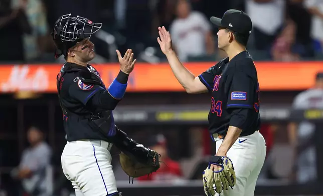 New York Mets pitcher Kodai Senga greets New York Mets catcher Luis Torrens after the ninth inning of a baseball game against the Washington Nationals, Friday, Aug. 14, 2026, in New York. (AP Photo/Heather Khalifa)