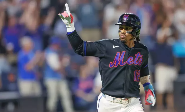 New York Mets' Francisco Lindor gestures after a home run during the sixth inning of a baseball game against the Washington Nationals, Friday, Aug. 14, 2026, in New York. (AP Photo/Heather Khalifa)
