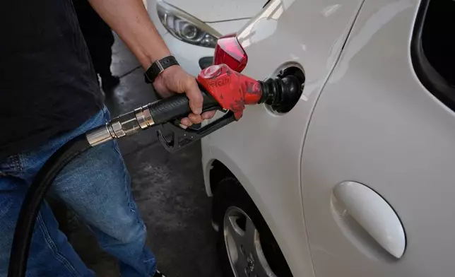 A man is filling up his car at a gas station in Tehran, Iran, Tuesday, Aug. 25, 2026. (AP Photo/Vahid Salemi)