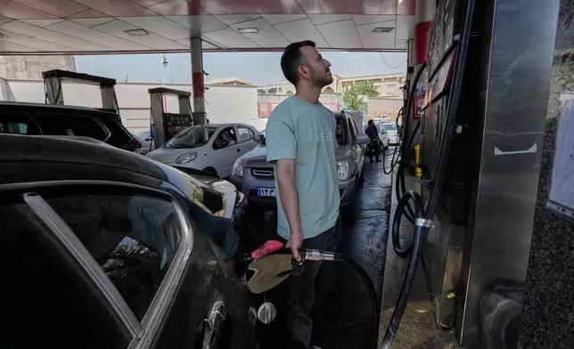 A man is filling up his car at a gas station in Tehran, Iran, Tuesday, Aug. 25, 2026. (AP Photo/Vahid Salemi)