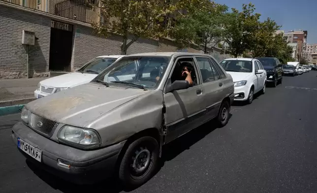 Cars line up outside a gas station in Tehran, Iran, Tuesday, Aug. 25, 2026. (AP Photo/Vahid Salemi)