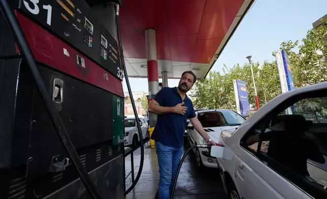 A man is filling up his car at a gas station in Tehran, Iran, Tuesday, Aug. 25, 2026. (AP Photo/Vahid Salemi)