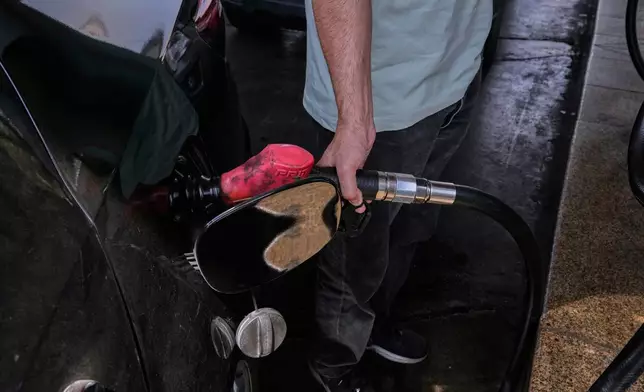 A man is filling up his car at a gas station in Tehran, Iran, Tuesday, Aug. 25, 2026. (AP Photo/Vahid Salemi)