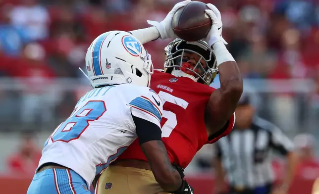 San Francisco 49ers wide receiver De'zhaun Stribling, right, catches a pass against Tennessee Titans defensive back Cor'Dale Flott during the first half of a preseason NFL football game, Thursday, Aug. 13, 2026, in Santa Clara, Calif. (AP Photo/Jed Jacobsohn)
