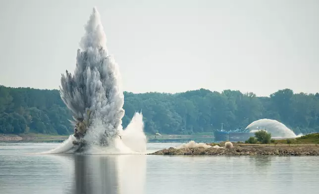 The Romanian Navy detonates underwater explosives during a controlled demolition of submerged rocks to improve water flow to the Cernavoda Nuclear Power Plant amid exceptionally low water levels on the Danube River, in Izvoarele, Romania, Monday, Aug. 3, 2026. (AP Photo/Andreea Alexandru)
