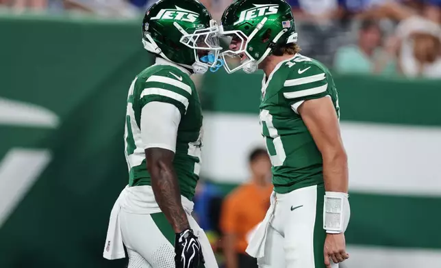 New York Jets running back Chip Trayanum (40) and Jets quarterback Cade Klubnik (10) react after scoring during the first half of a preseason NFL football game against the New York Giants, Friday, Aug. 28, 2026, in East Rutherford, N.J. (AP Photo/Adam Hunger)