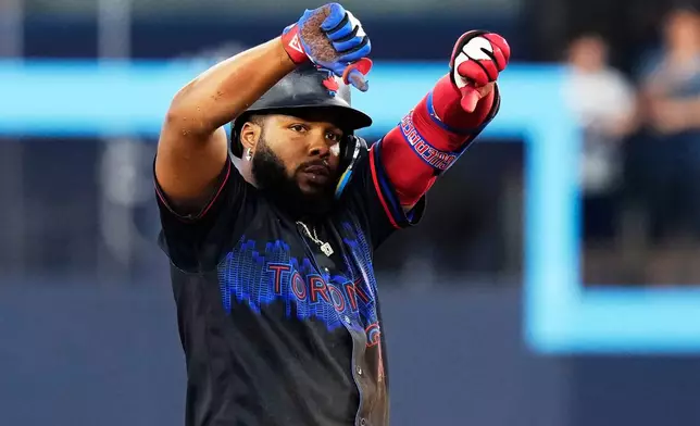 Toronto Blue Jays' Vladimir Guerrero Jr. (27) celebrates after hitting a double against the St. Louis Cardinals during sixth inning of a baseball game against the St. Louis Cardinals in Toronto, Friday, July 31, 2026. (Chris Young/The Canadian Press via AP)
