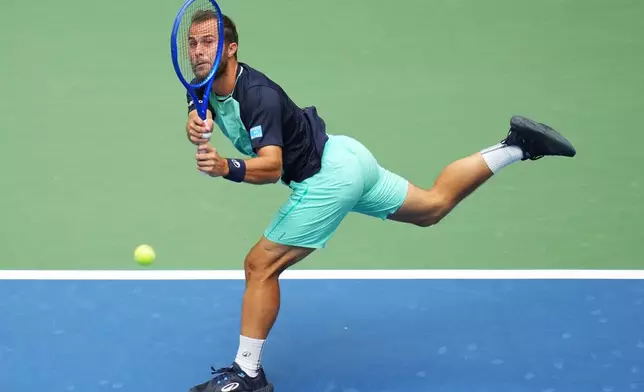 Hugo Gaston, of France, returns the ball to Daniil Medvedev, of Russia, during the first round of the U.S. Open tennis championships Sunday, Aug. 30, 2026, in New York. (AP Photo/Kirsty Wigglesworth)