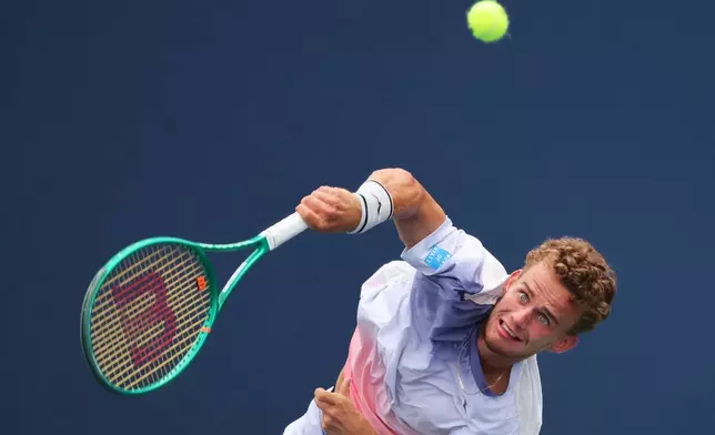 Luca van Assche, of France, returns the ball to Cameron Norrie, of Britain, during the first round of the U.S. Open tennis championships, Sunday, Aug. 30, 2026, in New York. (AP Photo/Andres Kudacki)