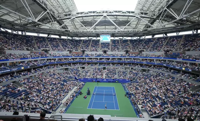 Daniil Medvedev, of Russia, serves the ball to Hugo Gaston, of France, top, during the first round of the U.S. Open tennis championships at Arthur Ashe Stadium on Sunday, Aug. 30, 2026, in New York. (AP Photo/Kirsty Wigglesworth)