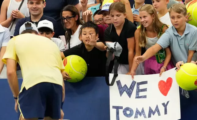Spectators ask for autographs from Tommy Paul, of the United States, after he defeated Coleman Wong, of Hong Kong, during the first round of the U.S. Open tennis championships Sunday, Aug. 30, 2026, in New York. (AP Photo/Yuki Iwamura)