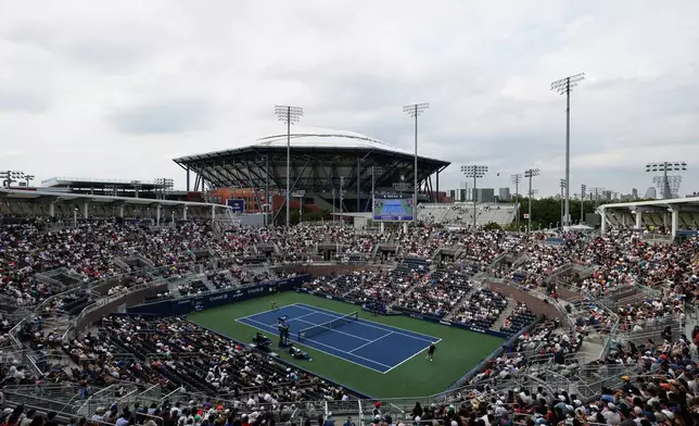 Tennis fans watch a match between Miomir Kecmanovic, of Serbia, and Denis Shapovalov, of Canada, during the first round of the U.S. Open tennis championships, Sunday, Aug. 30, 2026, in New York. (AP Photo/Adam Hunger)