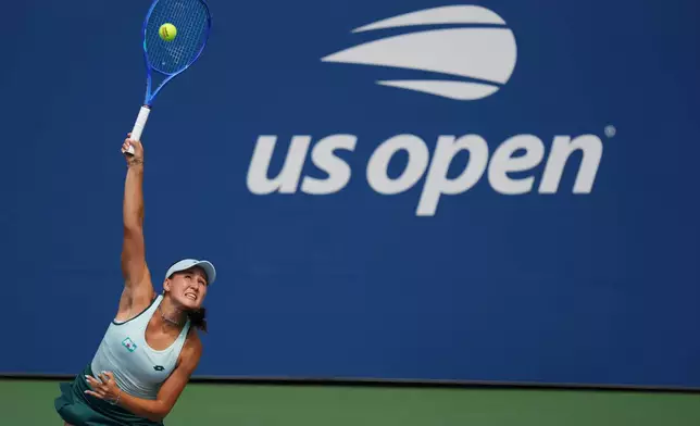Kamilla Rakhimova, of Uzbekistan, serves the ball to Barbora Krejcikova, of the Czech Republic, during the first round of the U.S. Open tennis championships Sunday, Aug. 30, 2026, in New York. (AP Photo/Kirsty Wigglesworth)