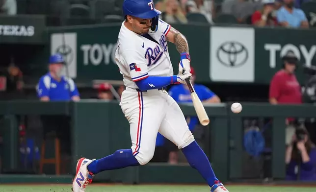 Texas Rangers' Cody Freeman hits a run scoring single during the third inning of a baseball game against the Washington Nationals, Tuesday, Aug. 18, 2026, in Arlington, Texas. (AP Photo/LM Otero)