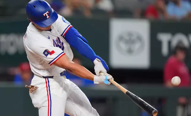 Texas Rangers' Justin Foscue launches a solo home run during the second inning of a baseball game against the Washington Nationals, Tuesday, Aug. 18, 2026, in Arlington, Texas. (AP Photo/LM Otero)
