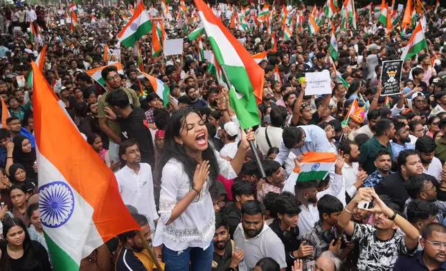 FILE- Protesters celebrate after Education Minister Dharmendra Pradhan resigned following nationwide protests as part of the Cockroach Janta Party's protest movement in Mumbai, India, Sunday, July 26, 2026. (AP Photo/Rafiq Maqbool, File)