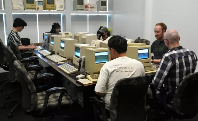 Attendees play on Apple Macintosh computers from the 1980s at the Vintage Computer Festival in Mountain View, Calif., Sunday, Aug. 2, 2026. (AP Photo/Terry Chea)