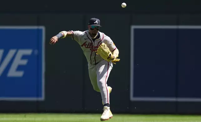 Atlanta Braves right fielder Ronald Acuña Jr. loses control of the ball while throwing after fielding a single hit by Minnesota Twins' Luke Keaschall during the fifth inning of a baseball game, Wednesday, Aug. 19, 2026, in Minneapolis. (AP Photo/Abbie Parr)
