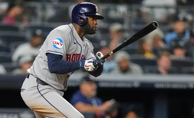 Houston Astros' Yordan Alvarez (44) follows through on a RBI triple during the eighth inning of a baseball game against the New York Yankees Tuesday, Aug. 25, 2026, in New York. (AP Photo/Frank Franklin II)