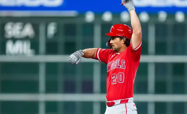 Los Angeles Angels' Adam Frazier reacts after hitting an RBI double against the Houston Astros during the fourth inning of a baseball game Thursday, Aug. 20, 2026, in Houston. (AP Photo/Eric Christian Smith)