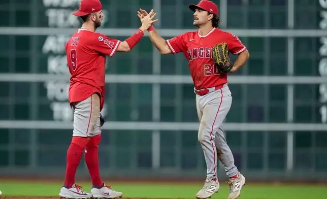 Los Angeles Angels' Zach Neto, left, and Adam Frazier celebrate the team's win over the Houston Astros in a baseball game Thursday, Aug. 20, 2026, in Houston. (AP Photo/Eric Christian Smith)