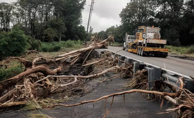 Debris is seen along Hawaiʻi Belt Road near Pahala, Hawaii, Sunday, Aug. 16, 2026, after a severe weather system went through the area. (Stephen Lam/San Francisco Chronicle via AP)