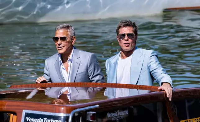 FILE - George Clooney, left, and Brad Pitt upon arrival for the press conference of the film 'Wolfs' during the 81st edition of the Venice Film Festival in Venice, Italy, on Sept. 1, 2024. (Photo by Joel C Ryan/Invision/AP, File)
