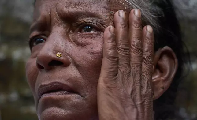 Kanchi Nepali, a flash flood survivor, waits to receive relief supplies in the Devighat area of Nuwakot district in Nepal, Friday, Aug. 28, 2026. (AP Photo/Niranjan Shrestha)