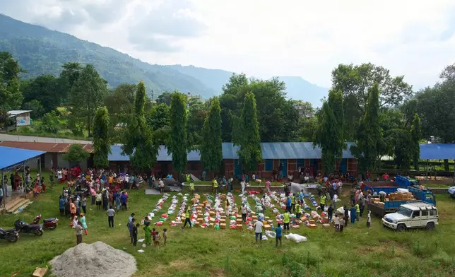 Volunteers prepare to distribute relief supplies to survivors in the Devighat area of Nuwakot district in Nepal, Friday, Aug. 28, 2026. (AP Photo/Niranjan Shrestha)