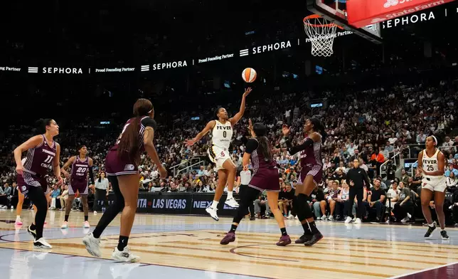 Indiana Fever's Kelsey Mitchell (0) scores past the Toronto Tempo defence during the first half of a WNBA basketball game in Toronto on Tuesday, Aug. 18, 2026. (Chris Young/The Canadian Press via AP)