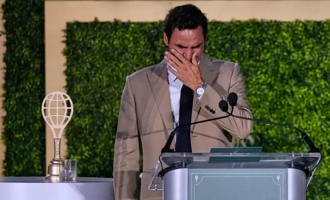 Roger Federer tries to hold back his tears during his induction ceremony at the International Tennis Hall of Fame, Saturday, Aug. 29, 2026, in Newport, R.I. (AP Photo/Charles Krupa)
