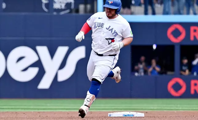 Toronto Blue Jays' Alejandro Kirk runs the bases after hitting a two-run home run against the Seattle Mariners during the first inning of a baseball game in Toronto, Sunday, Aug. 30, 2026. (Jon Blacker/The Canadian Press via AP)