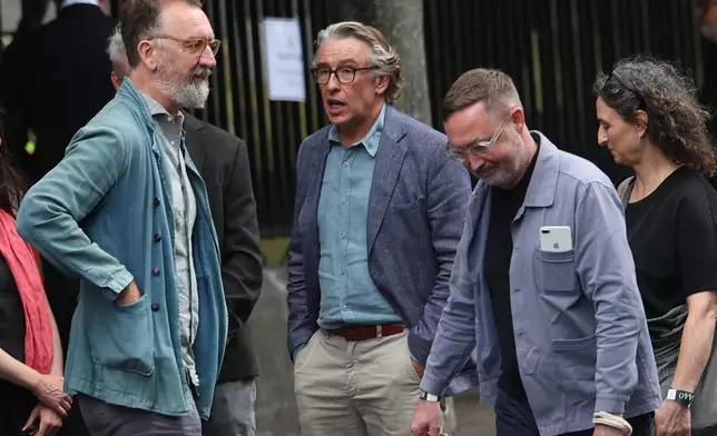 Steve Coogan and Chris O'Dowd arrive for the funeral of Glen Hansard at St Patrick's Cathedral in Dublin, Tuesday, Aug. 4, 2026. (Damien Eagers/PA via AP)