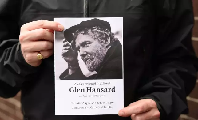 The Order of Service is held up ahead of the funeral of Glen Hansard at St Patrick's Cathedral in Dublin, Tuesday, Aug. 4, 2026. (Damien Eagers/PA via AP)