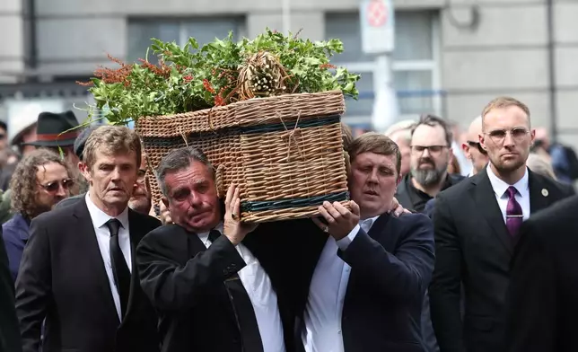 The coffin of Glen Hansard is carried into St Patrick's Cathedral for his funeral service, in Dublin, Tuesday, Aug. 4, 2026. (Damien Eagers/PA via AP)