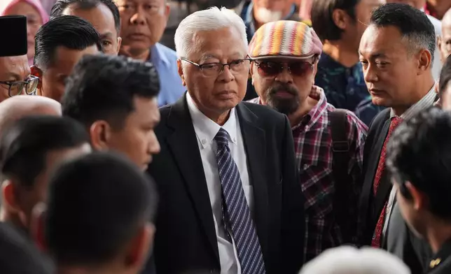 Malaysia's former Prime Minister Ismail Sabri Yaakob, center, arrives at courthouse for a corruption case in Kuala Lumpur, Malaysia, Thursday, Aug. 27, 2026. (AP Photo/Vincent Thian)