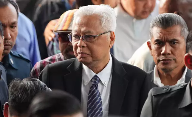 Malaysia's former Prime Minister Ismail Sabri Yaakob, center, arrives at courthouse for a corruption case in Kuala Lumpur, Malaysia, Thursday, Aug. 27, 2026. (AP Photo/Vincent Thian)