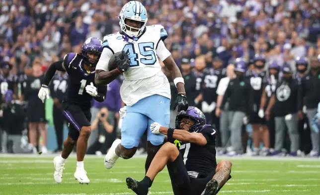 TCU safety Julius Simms, right, tackles North Carolina tight end Jelani Thurman during an NCAA college football game in Dublin, Ireland. Saturday, Aug. 29, 2026. (AP Photo/Peter Morrison)