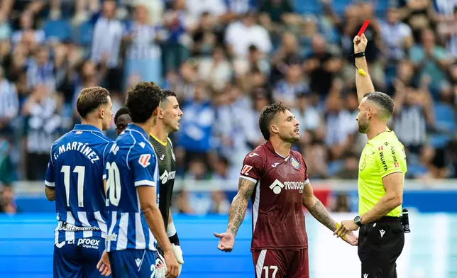 Getafe player Kiko Femenia receives a red card during a Spanish La Liga soccer match against Deportivo Alavés at Mendizorrotza Stadium in Vitoria, Spain, Saturday, Aug. 15, 2026. (AP Photo/Pablo Garcia)