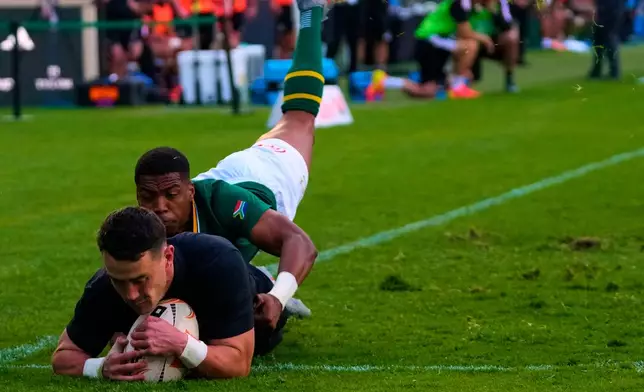 New Zealand's Will Jordan, front, scores a try as South Africa's Grant Williams tries to defend during a Test rugby match between South Africa and New Zealand, in Johannesburg, South Africa, Saturday, Aug. 22, 2026. (AP Photo/Themba Hadebe)