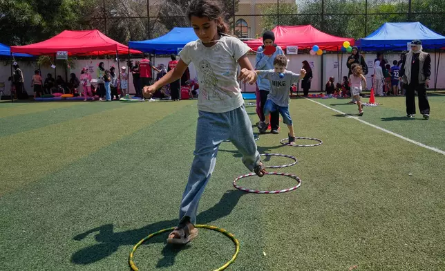 Displaced children attend an event organised by Save the Children, at a public school turned into a shelter for people whose villages in southern Lebanon were destroyed or occupied by Israeli forces, in Tyre, southern Lebanon, Thursday, Aug. 27, 2026. (AP Photo/Hussein Malla)