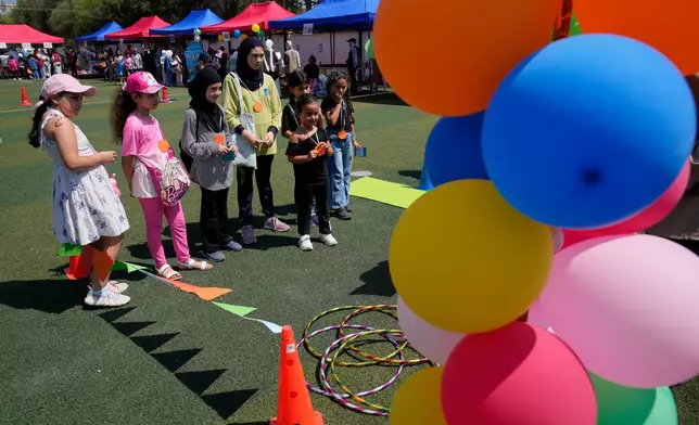 Displaced children attend an event organised by Save the Children, at a public school turned into a shelter for people whose villages in southern Lebanon were destroyed or occupied by Israeli forces, in Tyre, southern Lebanon, Thursday, Aug. 27, 2026. (AP Photo/Hussein Malla)
