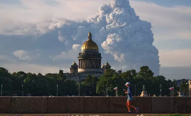FILE - Smoke rises following a Ukrainian drone attack on a warehouse for online retailer Wildberries in St. Petersburg, Russia on Friday, July 24, 2026, with St. Isaac's Cathedral seen in foreground. (UGC via AP, File)