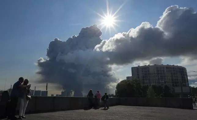 FILE - Smoke rises following a Ukrainian drone strike on a warehouse belonging to online retailer Wildberries, in St. Petersburg, Russia, on Friday, July 24, 2026. (UGC via AP, File)