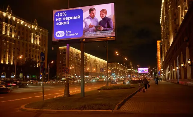 A billboard advertising 10% off an order from online retailer Wildberries looms over a main street in Moscow, Russia, late Wednesday, Aug. 12, 2026. (AP Photo/Alexander Zemlianichenko)