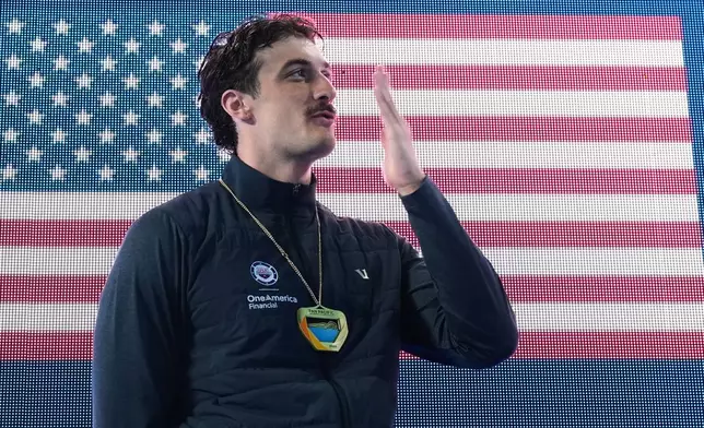 Van Mathias, of the United States, celebrates after winning the 100 meters breaststroke at the Pan Pacific Swimming Championships Thursday, Aug. 13, 2026 in Irvine, Calif. (AP Photo/Gregory Bull)